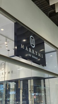 Vilnius Lithuania - 21.03.2026, Marryme by ribas illuminated boutique sign on a modern glass storefront inside a shopping mall interior