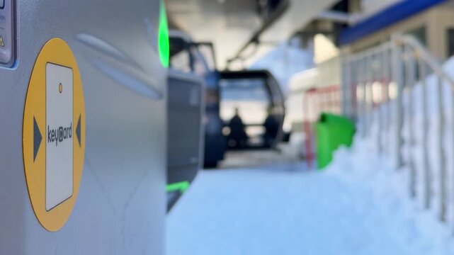 Mestia, Georgia - 2026: tourist skier uses ski pass tap the KeyCard reader at a mountain lift. This cinematic close up captures the seamless tech - driven experience of modern ski resorts