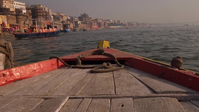 Boat POV Approaching Varanasi Ghats at Sunrise on Ganges River, Golden Morning Light, Spiritual India, Ancient City Architecture, Pilgrimage and Cultural Heritage Scene 4K Footage, India