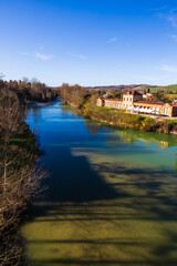 Fototapeta premium Banks of the Hers river seen from the Pont Neuf in Mazères, Occitanie, France