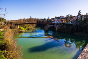 Obraz premium Old bridge of Mazères and its new pedestrian footbridge crossing the Hers river, Occitanie, France