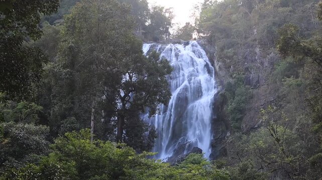 The video background features a natural setting with beautiful tourist attractions in Thailand, such as Khlong Lan Waterfall in Nakhon Nayok, which is always visited by travelers, both Thai and foreig