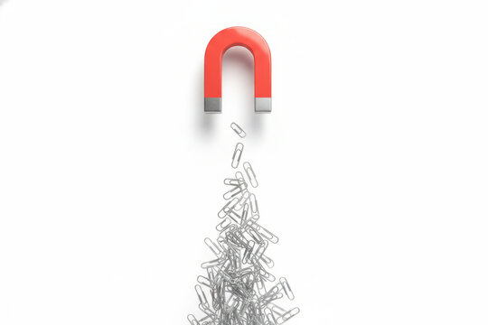 Red horseshoe magnet pulling a pile of flying paperclips upwards, ideal for business marketing concepts, customer lead generation strategy or leadership power metaphors