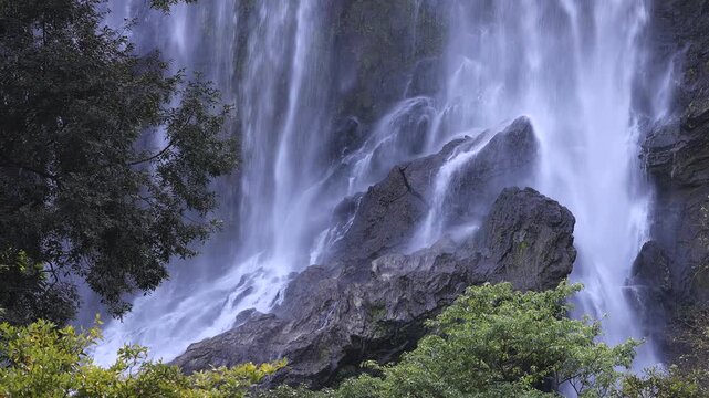 The video background features a natural setting with beautiful tourist attractions in Thailand, such as Khlong Lan Waterfall in Nakhon Nayok, which is always visited by travelers, both Thai and foreig