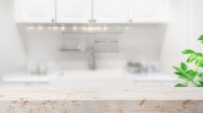 Selective focus.White vintage rustic wood table island  with cozy white wall kitchen background for design product