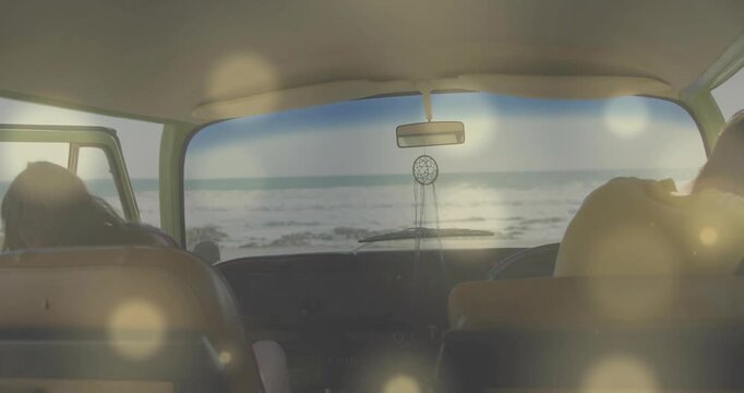 Woman and man in seats leaning, opening doors, stepping out to view ocean with dreamcatcher, travel