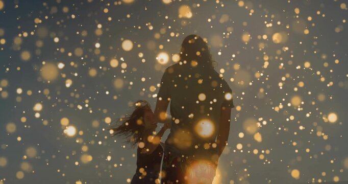 Vertical video: Adult and kid holding hands spinning sun gold drifting waving hat playful education