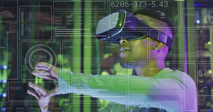 VR tester standing in server room, HUD appearing and causing hand gestures while analyzing data