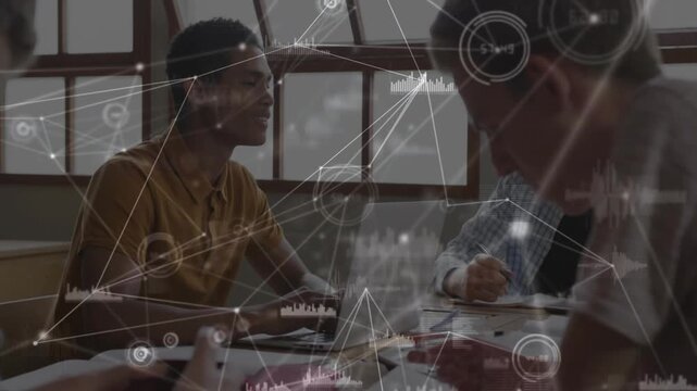 Mustard-polo student typing, leading peers in study, taking notes on laptop with network overlay