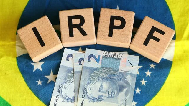 IRPF, Imposto de Renda de Pessoa F&iacute;sica, English translation Personal Income Tax. Financial concept. Taxes in Brazil. written on wooden blocks, Brazilian flag, business background