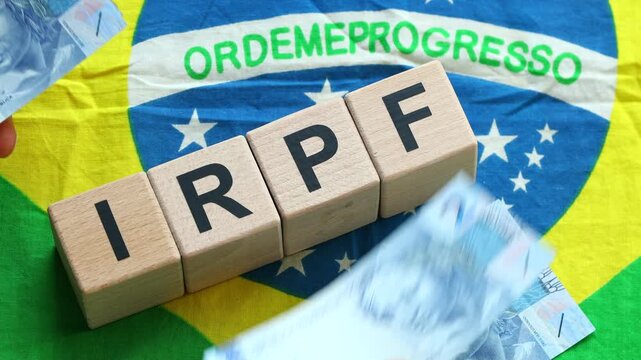 IRPF, Imposto de Renda de Pessoa F&iacute;sica, English translation Personal Income Tax. Financial concept. Taxes in Brazil. written on wooden blocks, Brazilian flag, business background