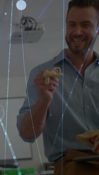 Vertical video: Tutor picking mini ear part, rotating and teaching anatomy with blue overlay