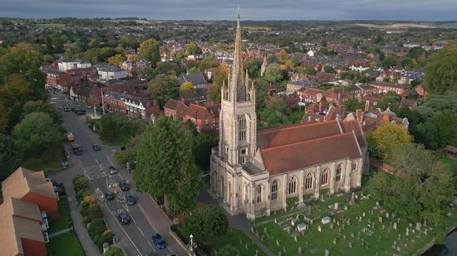 Aerial view of a quaint town with a prominent church and spire.