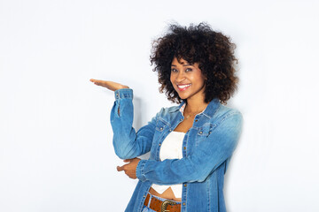 young woman with afro hair isolated on background pointing