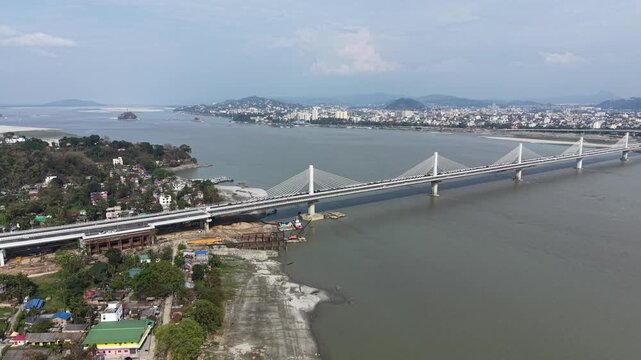 Cinematic view of Kumar Bhaskar Varma Setu bridge connecting rural North Guwahati to the city over Brahmaputra river, Assam