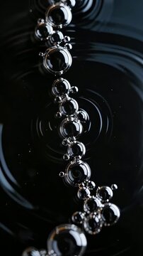 Crystal clear water droplets and bubbles against a black background
