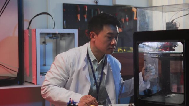 Researcher adjusts nozzle and filament carefully, Clothing and tools used during detailed equipment inspection