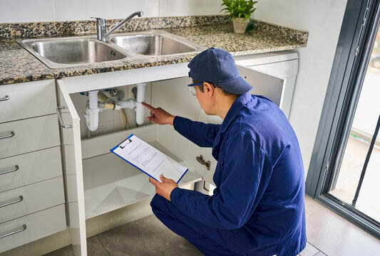 Plumber,house and handyman with clipboard,inspection and maintenance with expert. Employee, contractor and repair with checklist, service or quality control with industry, at home renovation or skills
