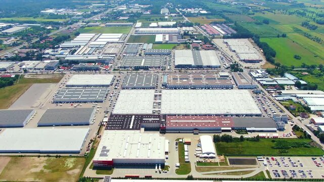 Aerial drone footage of vast industrial park complex with many warehouses and logistics centers