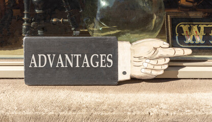 Advantages symbol. Concept word Advantages on beautiful black wooden sign as a hand. Beautiful...