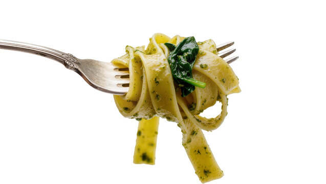 Isolated fresh tagliatelle pasta with green pesto and spinach twisted around a metal fork