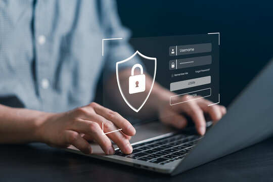 Man hand typing on laptop keyboard with virtual login form and shield padlock icon, representing user authentication, cybersecurity, web data privacy, and secure internet access technology.