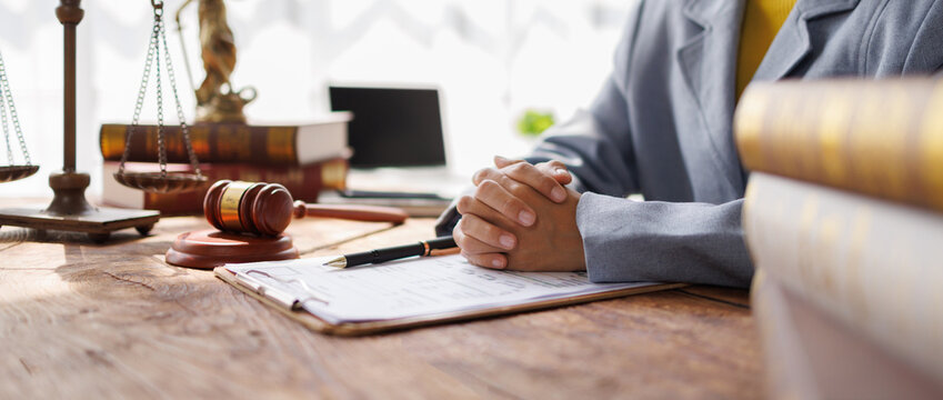 Lawyers Consultation and conference discussing legal matters at a desk with a gavel, scales of justice law symbolizing law and justice, justice and lawyer Business partnership meeting concept.