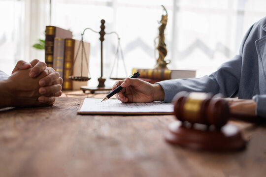 Contract, signing and lawyer consulting a client in his office with legal paperwork or agreement. Signature, approval and businessman in discussion with a woman with a document to sign in workplace. 