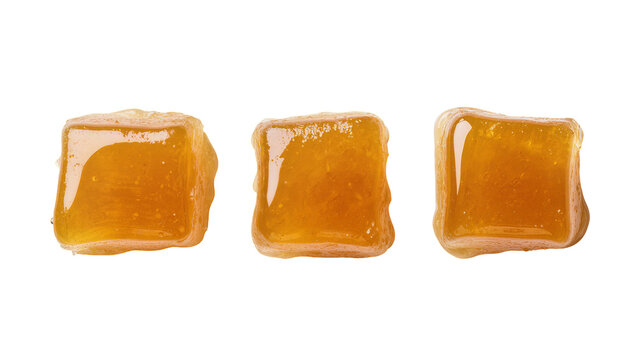Isolated delicious golden honey-flavored gummy cubes dripping, tempting sweet confectionery.