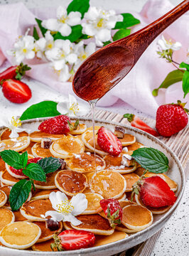 Mini pancakes with strawberries and mint. Pancakes. Breakfast.