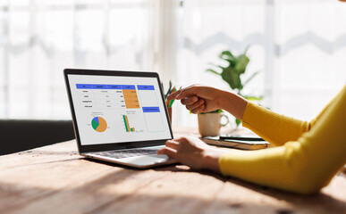 Business hand point to graphs and charts to analyze market data, balance sheet, account, net profit...