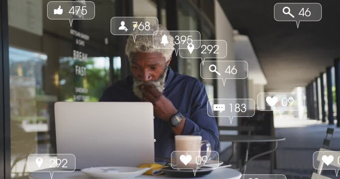 Animation of social media icons over businessman wearing face mask