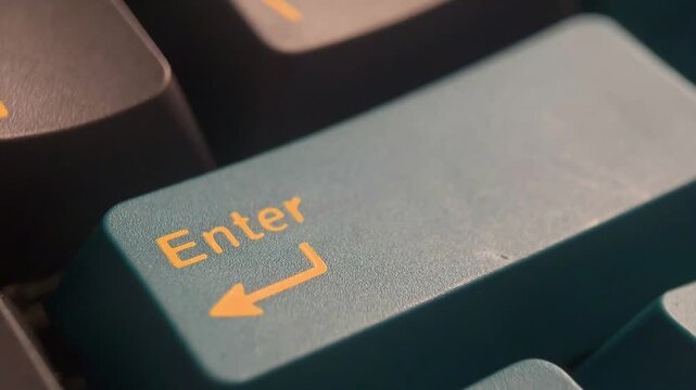 Close up of the Enter key on the keyboard being pressed