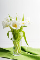 Closeup bouquet of White tulips with fringe in a transparent glass vase