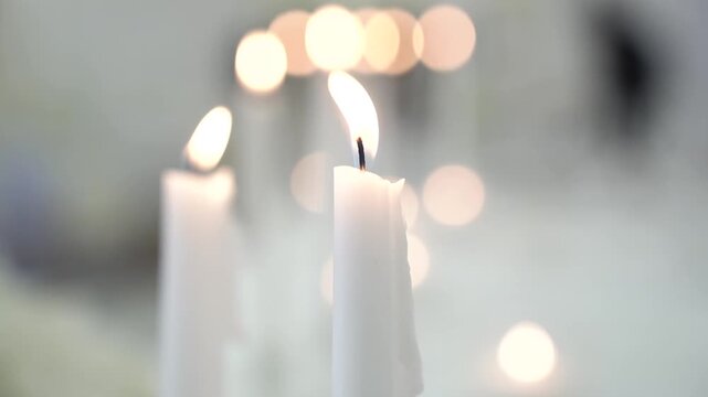 Single burning candle flame with beautiful golden bokeh background