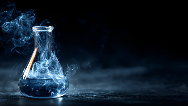 A glass flask filled with blue liquid and swirling wisps of smoke against a dark backdrop. The glass rests on a textured surface