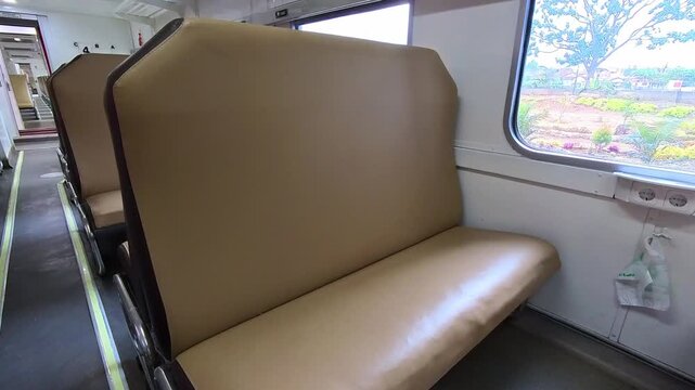 First-person video inside an empty train carriage with no passengers and stopped at a station. Footage traveling along a local Indonesian train in Steady 4k High Resolution