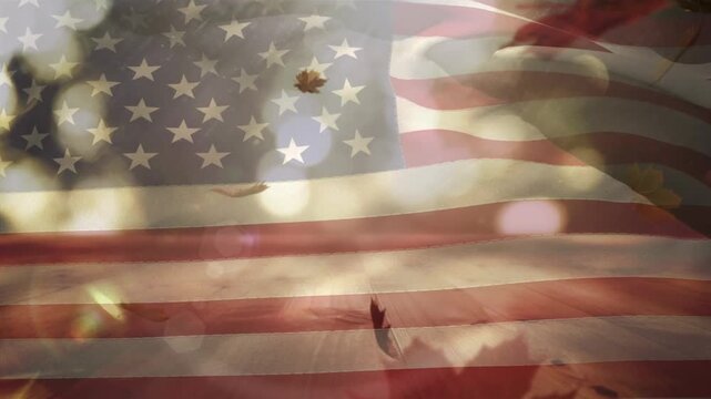 Composite of waving american flag against maple leaves falling over wooden surface