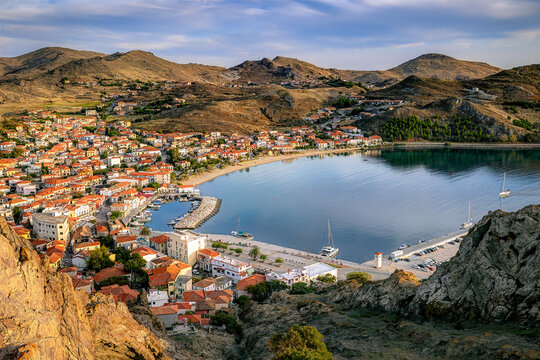 Lemnos Myrina, greece, showcasing the coastal town with its charming harbor, traditional houses climbing arid hills, and calm bay