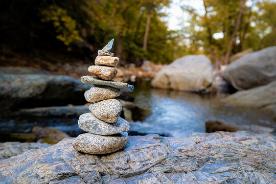 Samothraki Fonia Gorge. Cairn of balanced rocks creating a harmonious symbol by stream in natural environment.