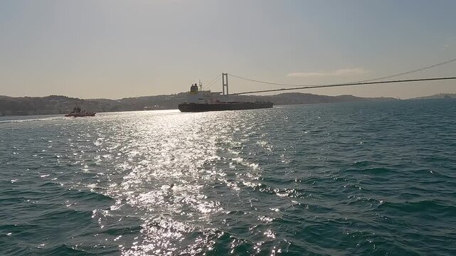 Cargo Ship Passing Through Bosphorus Strait. Bulk Carrier Ship, Bosphorus Strait, Turkey. Sea freight and transport logistics. Passage of cargo ships and tankers through the Bosphorus Strait.