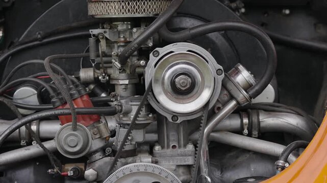 Close-up of a vintage car engine with visible parts and mechanics