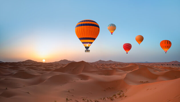 Hot air balloon flying over beautiful sand dunes in the Sahara desert - Sahara, Morocco