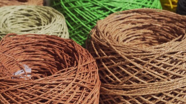 Close-up of raffia skeins. ECO raw material. Multi-colored raffia balls ready for knitting.