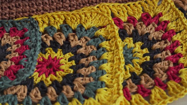 Granny square, close-up. ECO-raw materials. Multi-colored raffia squares.