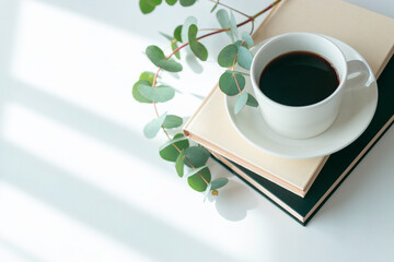 Hot coffee with book and pink flower in sunlight minimal morning lifestyle with copy space