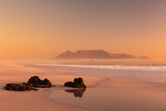 scenic view of table mountain from bloubergstrand at sunset in cape town south africa