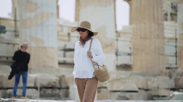Portrait of elegant tourist exploring ancient ruins at Acropolis in Athens, Greece