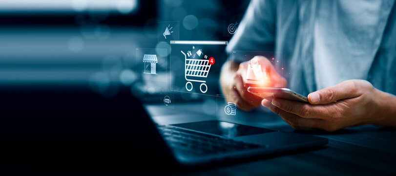 Business professional using smartphone with online shopping cart interface, digital commerce icons, and purchase notification, representing ecommerce transaction, mobile shopping, retail technology
