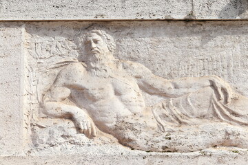 Relief Depicting the Tiber River God at the Base of the Giuseppe Gioachino Belli Monument in Rome, Italy © Monica